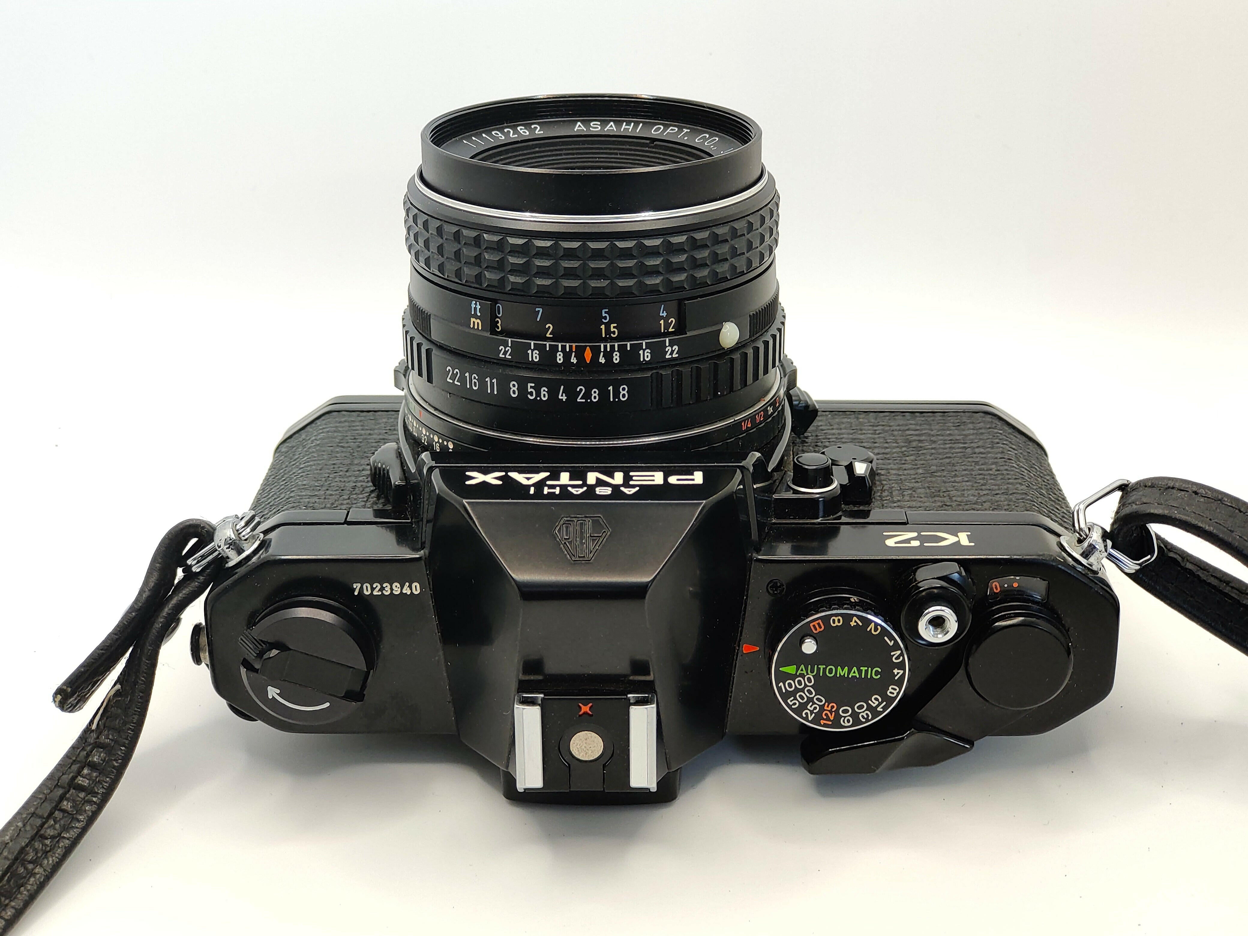 Pentax K2 SLR film camera with 55mm f/1.8 lens and case. In superb