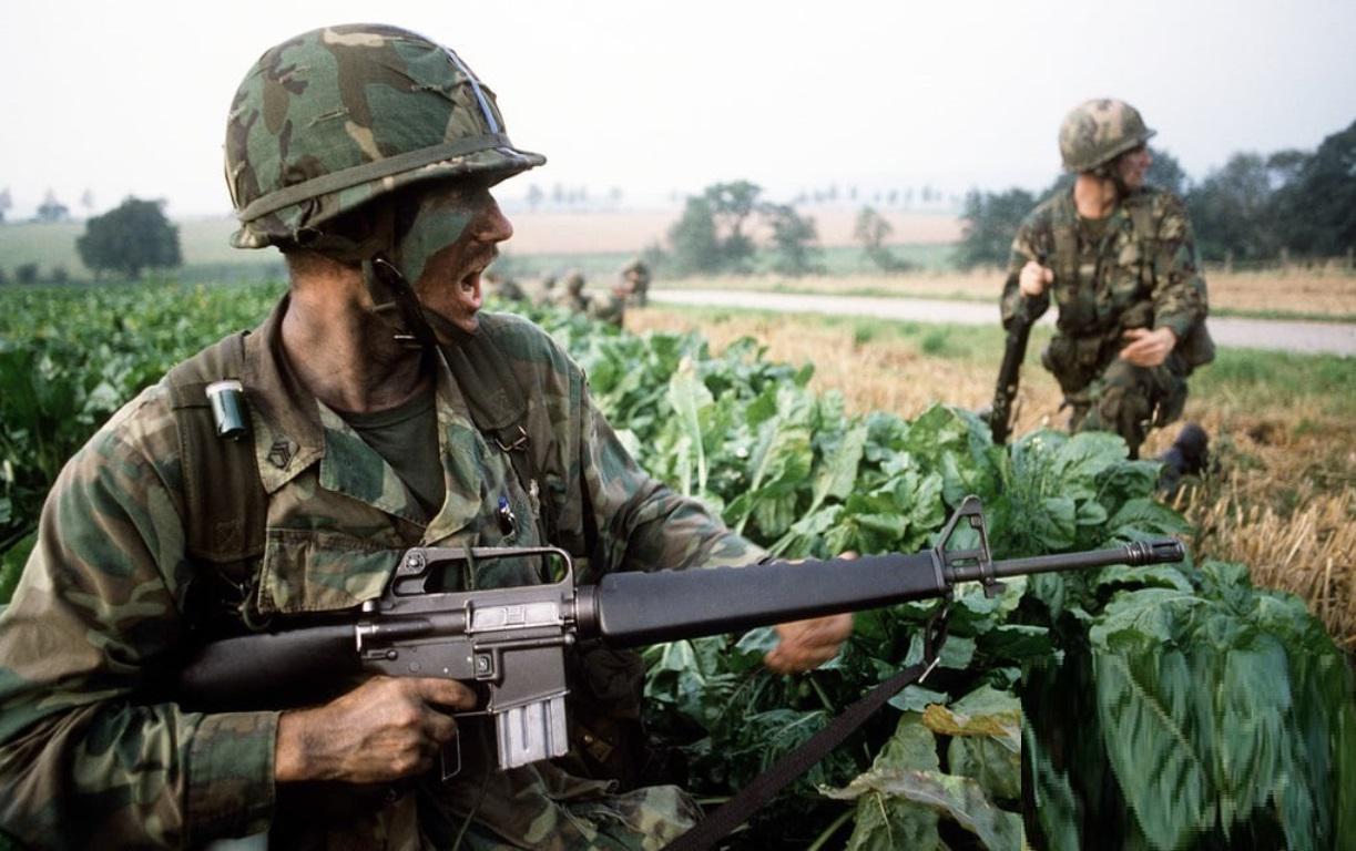 US Army paratroopers on the ground after parachuting into a field